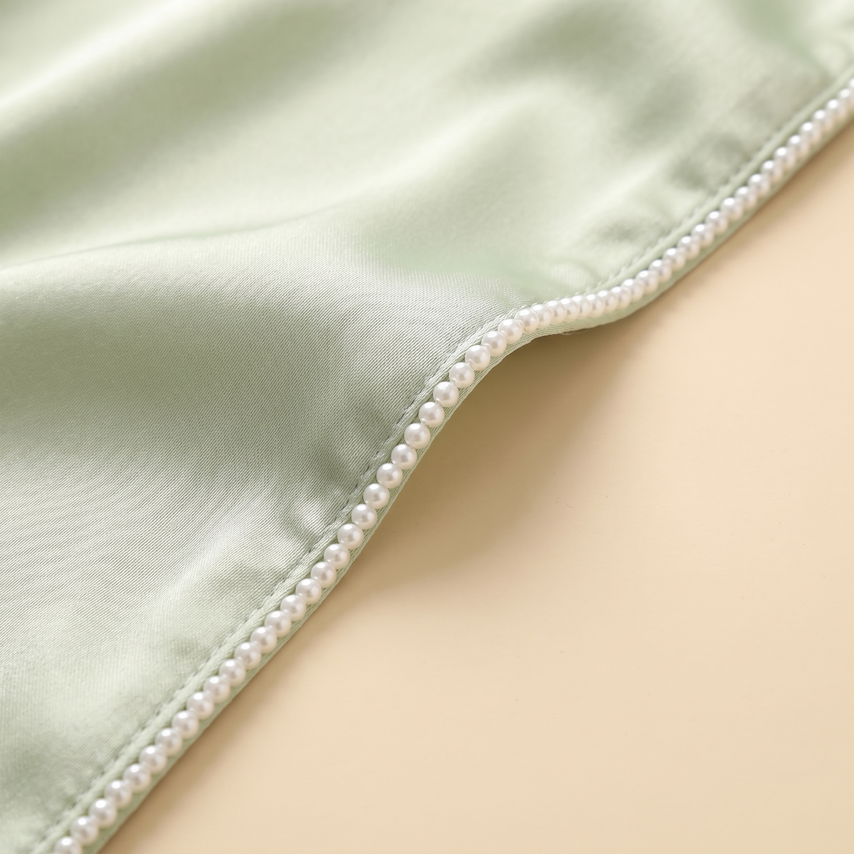 Thuraya beaded satin set — pearl-bead trim detail