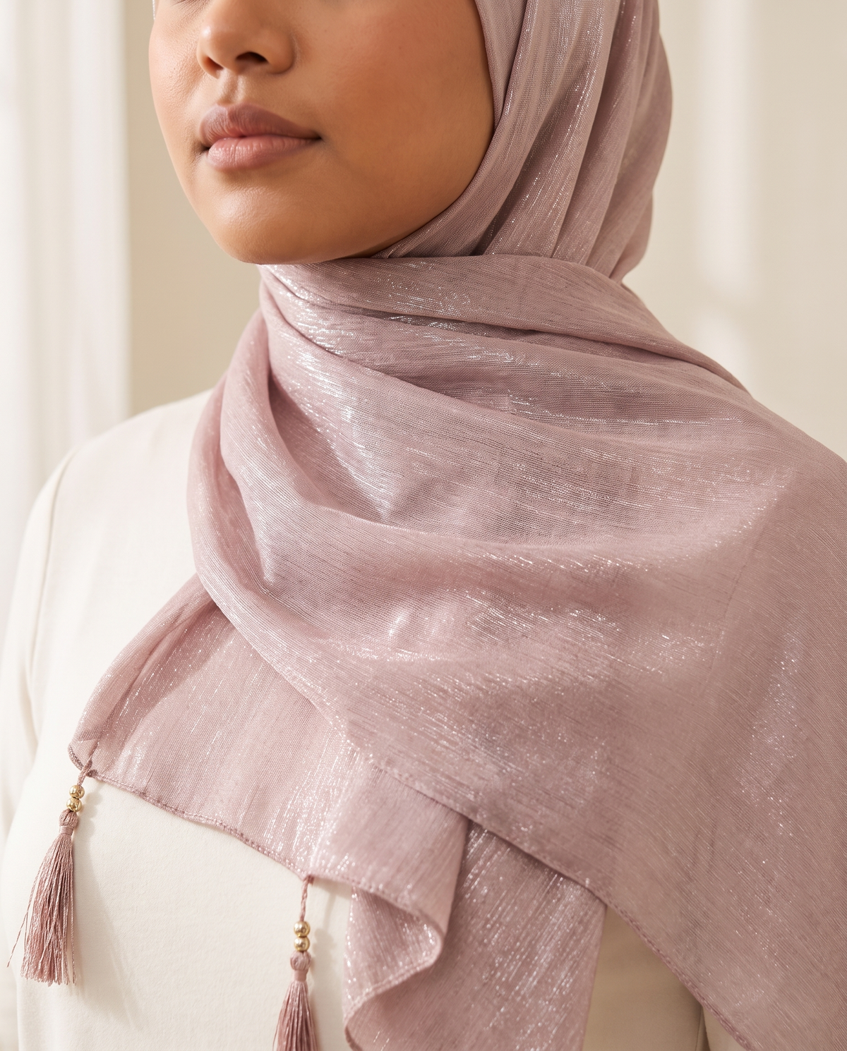 Yara tasseled shimmer shawl in Dusty Pink, worn